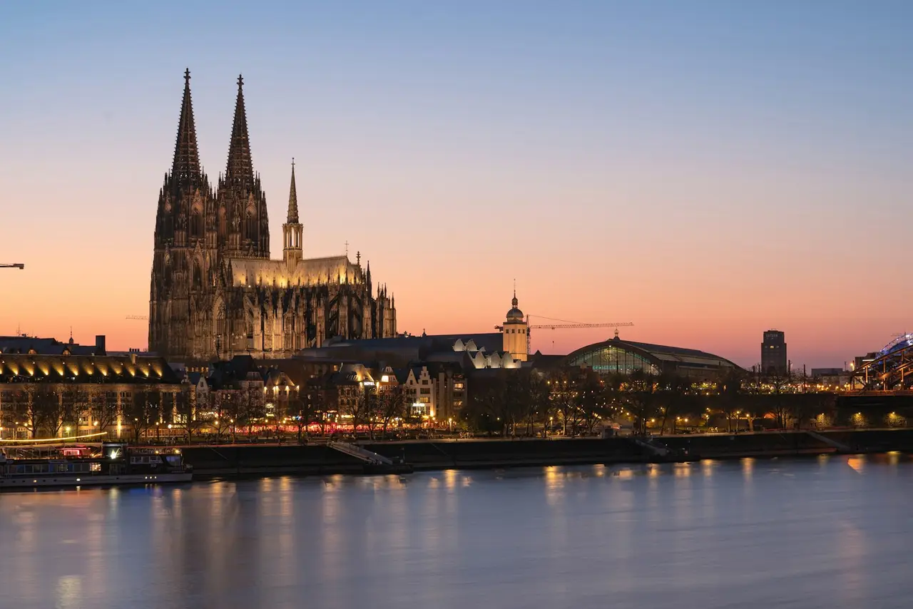 Cologne cathedral at dusk, reflected in the water.